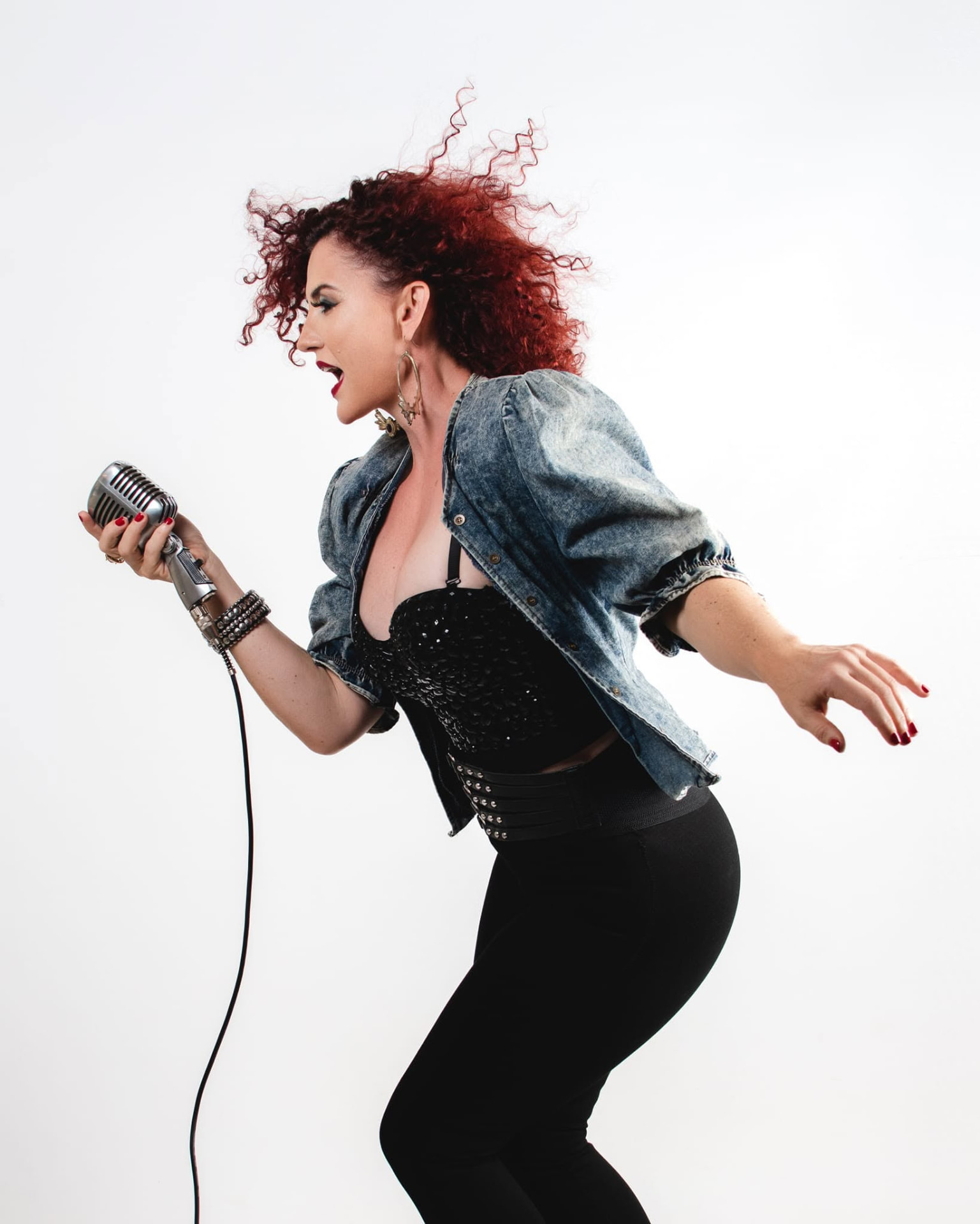 Rene Hunter in a studio portrait with a vintage microphone